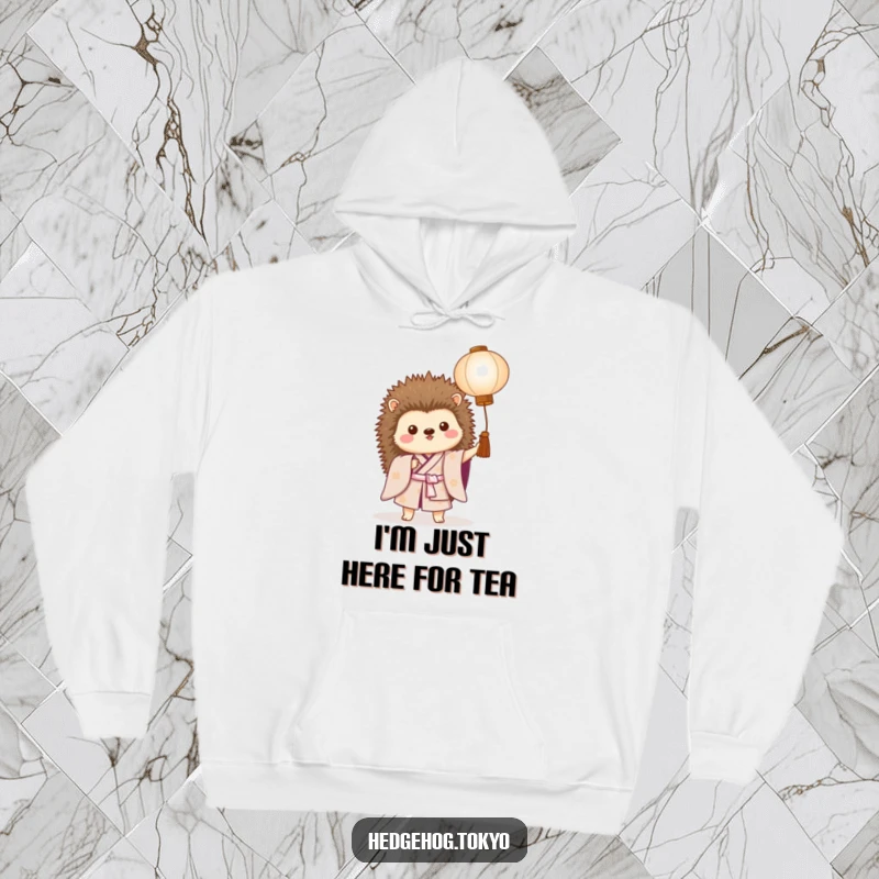 Funny hoodie depicting a proud hedgehog in a kimono, holding a paper lantern, offering warm comfort and a good laugh.
