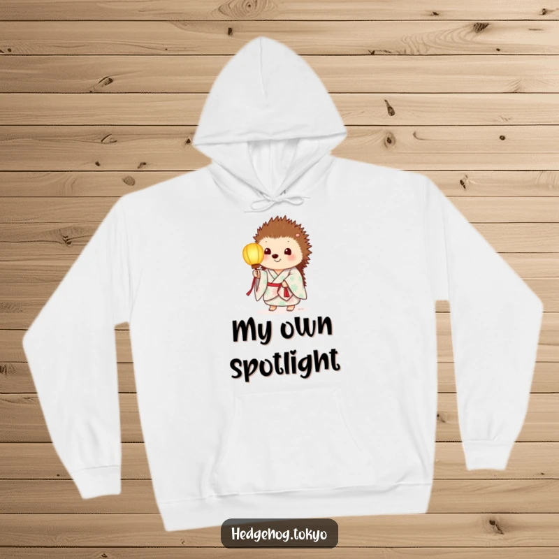 Funny hoodie with a hedgehog in a summer kimono, holding a paper lantern that casts a gentle, warm light.