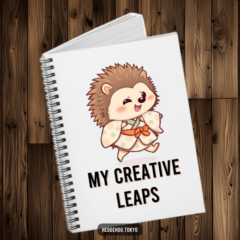 Funny hedgehog wearing a patterned kimono is depicted on a notebook cover, doing a playful hop, inspiring creativity.