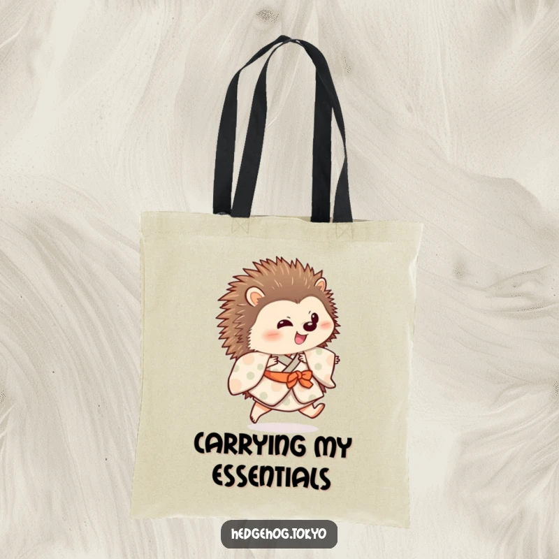 Funny hedgehog wearing a patterned kimono is depicted on a tote bag, doing a playful hop with one leg extended.