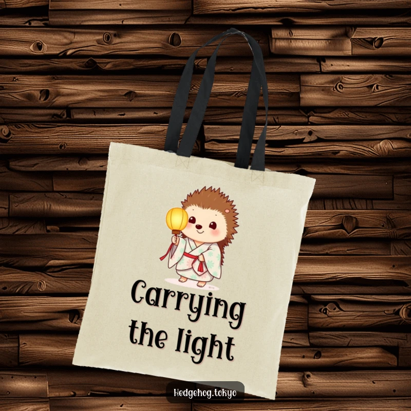 Funny tote bag showcasing a hedgehog in a summer kimono, holding a softly glowing paper lantern, perfect for carrying essentials.